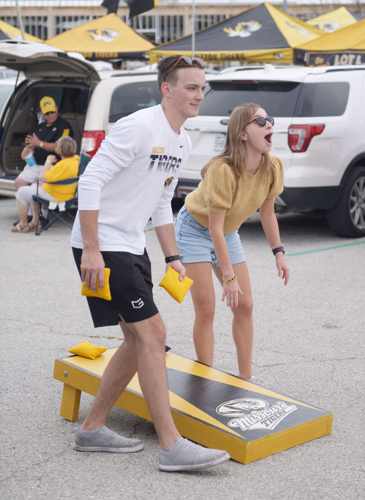 Left, Thomas Smith and Rebecca Potje play cornhole during a tailgate (copy)